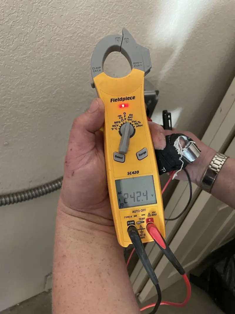 Voltage testing with clamp meter during Electrical Installation Services in Silt